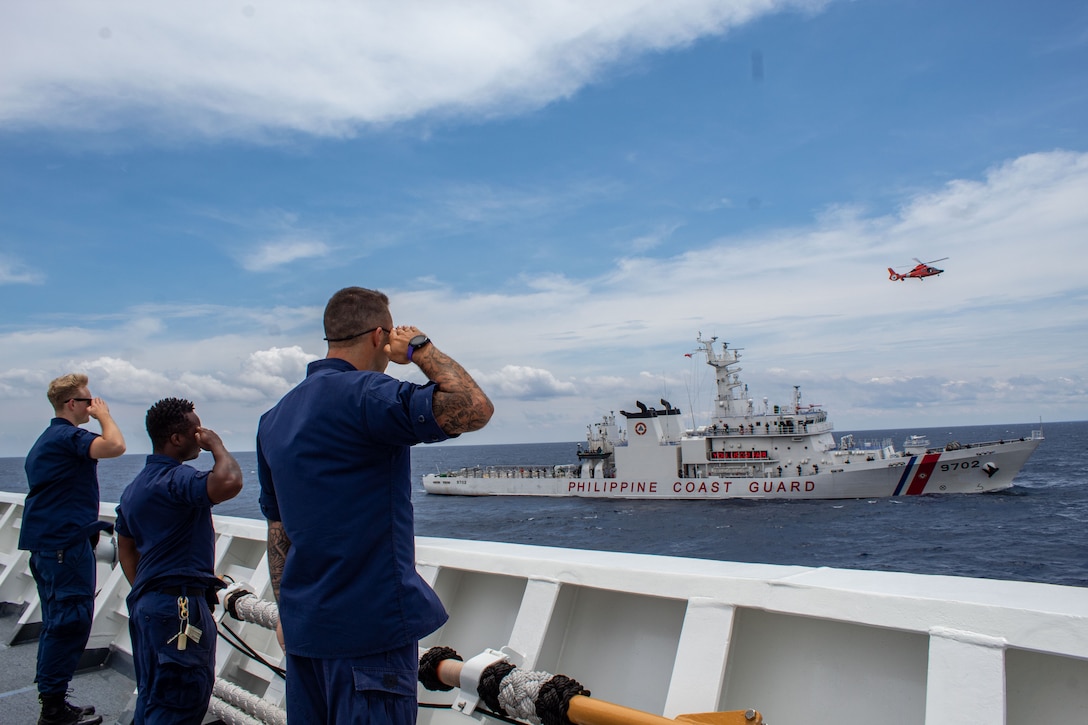 U.S. Coast Guardsmen, assigned to the U.S. Coast Guard Cutter Waesche (WMSL 751), render honors to members of the Philippine Coast Guard, assigned to the Philippine Coast Guard Vessel Melchora Aquino (MRRV-9702), from aboard the Waesche during a bilateral U.S.-Philippine search and rescue exercise in the  South China Sea, July 16, 2024. The bilateral exercise was an opportunity to strengthen relations by working together and exchanging operating procedures and practices. Waesche is the second U.S. Coast Guard National Security Cutter deployed to the Indo-Pacific in 2024. Coast Guard cutters routinely deploy to the region to engage with partner nations to ensure a free and open Indo-Pacific.  (U.S. Coast Guard photo by Ensign Julia VanLuven)