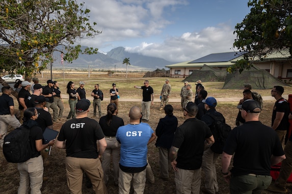 Members from the 33rd Weapons of Mass Destruction-Civil Support Team (WMD-CST) attend a pre-brief during a weapons of mass destruction exercise with civilian agencies, the Hawaii National Guard, and a half dozen other integrated CST teams and CBRNE Enhanced Response Force Packages (CERFP). The exercise poised military and civilian response partners to better integrate capabilities when disaster strikes.