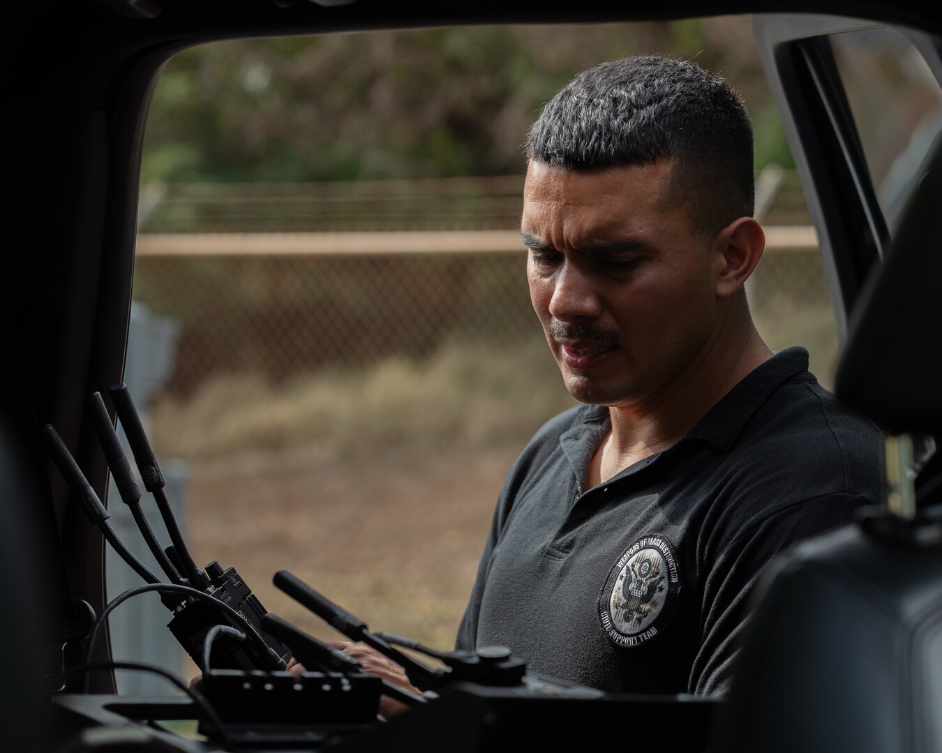 U.S. Army Sgt. 1st Class Daniel F. Billingsley, communications chief, 33rd Weapons of Mass Destruction-Civil Support Team (WMD-CST), tests radio transmissions during a training exercise in Lihue, Hawaii, on June 7, 2024. The exercise poised military and civilian response partners to better integrate capabilities when disaster strikes.