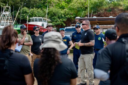 U.S. Army MAJ Keith Hapenney, commander, 33rd WMD-CST, conducts a post-brief during a weapons of mass destruction exercise with civilian agencies, the Hawaii National Guard, and a half dozen other integrated CST teams and CBRNE Enhanced Response Force Packages (CERFP). The exercise poised military and civilian response partners to better integrate capabilities when disaster strikes.