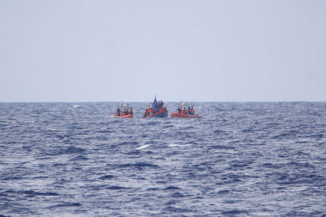 Small boat crews from Coast Guard Cutter Valiant (WMEC 621) and Coast Guard Cutter William Trump (WPC 1111) interdict an overloaded migrant vessel, June 6, 2024, while underway in the Windward Passage. Valiant and its crew conducted a 49-day maritime safety and security patrol in the Florida Straits and Windward Passage. (U.S. Coast Guard photo)