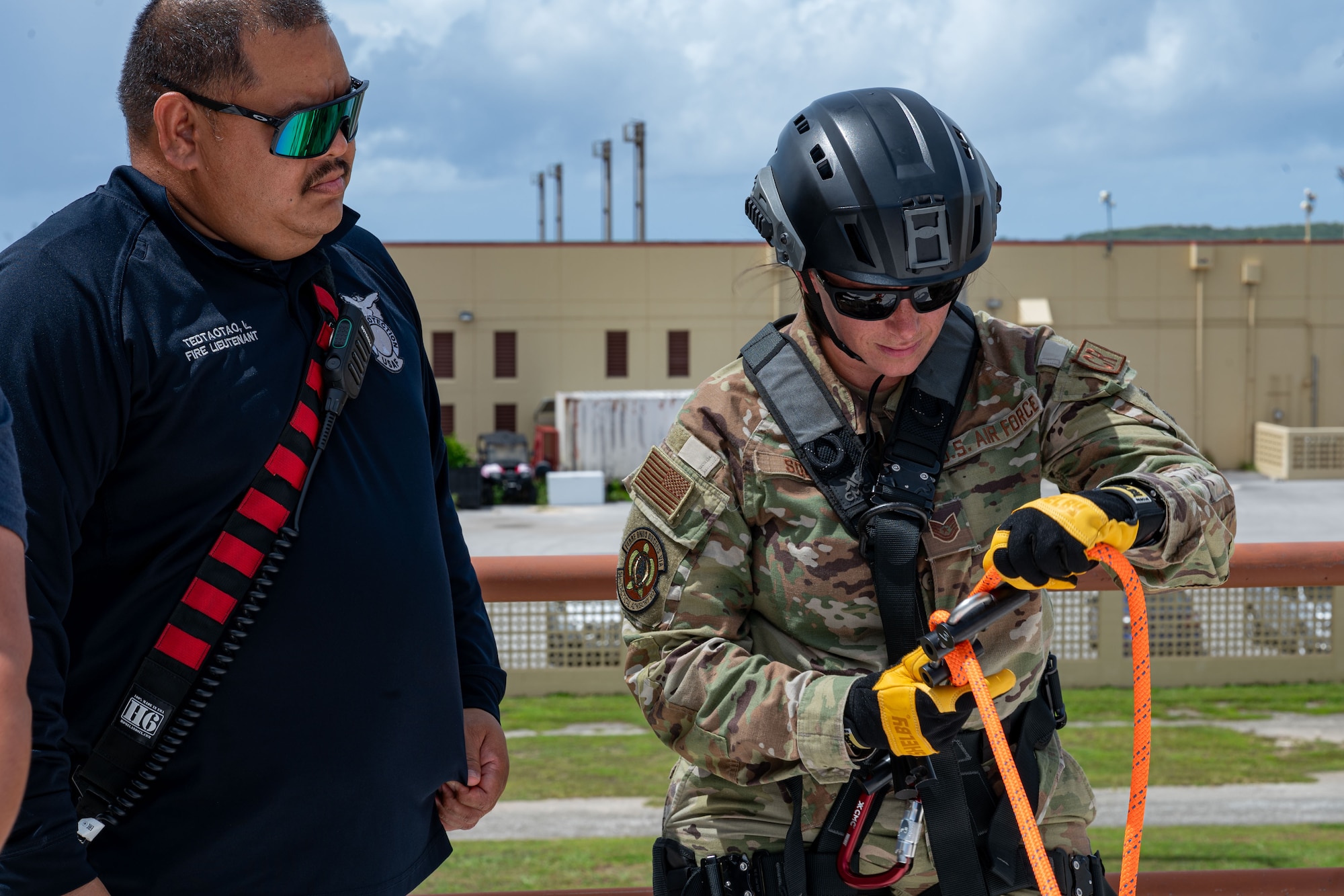 U.S. Air Force Tech. Sgt. Brittany Souder, left, 36th Tactical Advisory Squadron independent duty medical technician, and Tech. Sgt. Kyle Yeomans, 36 TAS survival, evasion, resistance and escape specialist, rappel during rescue technician training at Andersen Air Force Base, Guam, July 16, 2024.