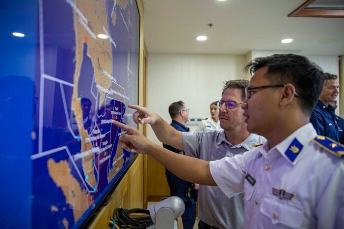 240709-N-SF508-1253 CAM RANH INTERNATIONAL PORT, Vietnam (July 9, 2024) – Douglas Samp, center right, U.S. Coast Guard Pacific Area Search and Rescue Program Manager, speaks with a member of the Vietnam Coast Guard as part of a joint U.S. – Vietnam subject matter expert exchange between members of the U.S. Coast Guard, U.S. 7th Fleet, and Vietnamese Navy and Coast Guard during a port visit by the U.S. 7th Fleet flagship USS Blue Ridge (LCC 19) and the U.S. Coast Guard Legend-class cutter USCGC Waesche (WMSL 751), in Cam Ranh, Vietnam, July 9, 2024. U.S. 7th Fleet is the U.S. Navy's largest forward-deployed numbered fleet, and routinely interacts and operates with allies and partners in preserving a free and open Indo-Pacific region. (U.S. Navy photo by Mass Communication Specialist 1st Class Charles Oki)
