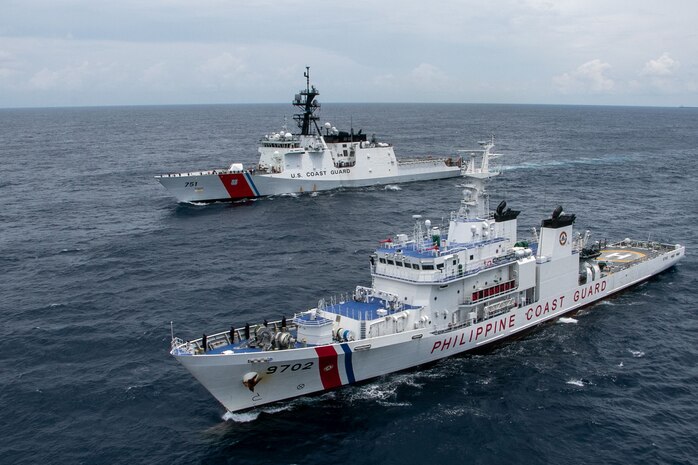 U.S. Coast Guardsmen, assigned to U.S. Coast Guard Cutter Waesche (WMSL-751), pass honors to members of the Philippine Coast Guard, assigned to Philippine Coast Guard Vessel Melchora Aquino (MRRV-9702), during a bilateral search and rescue exercise in the South China Sea, July 16, 2024.