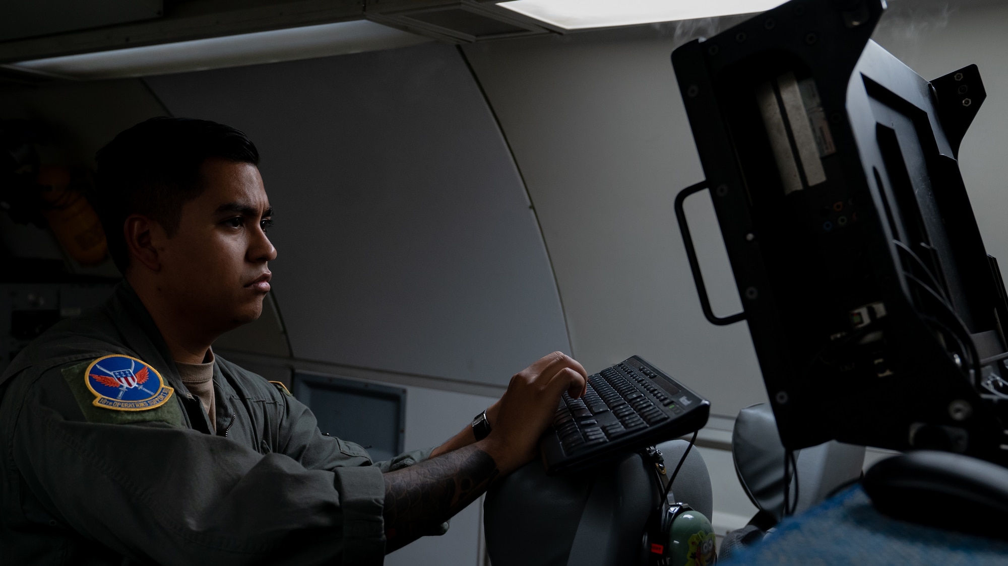 Airman operating AWACS computer