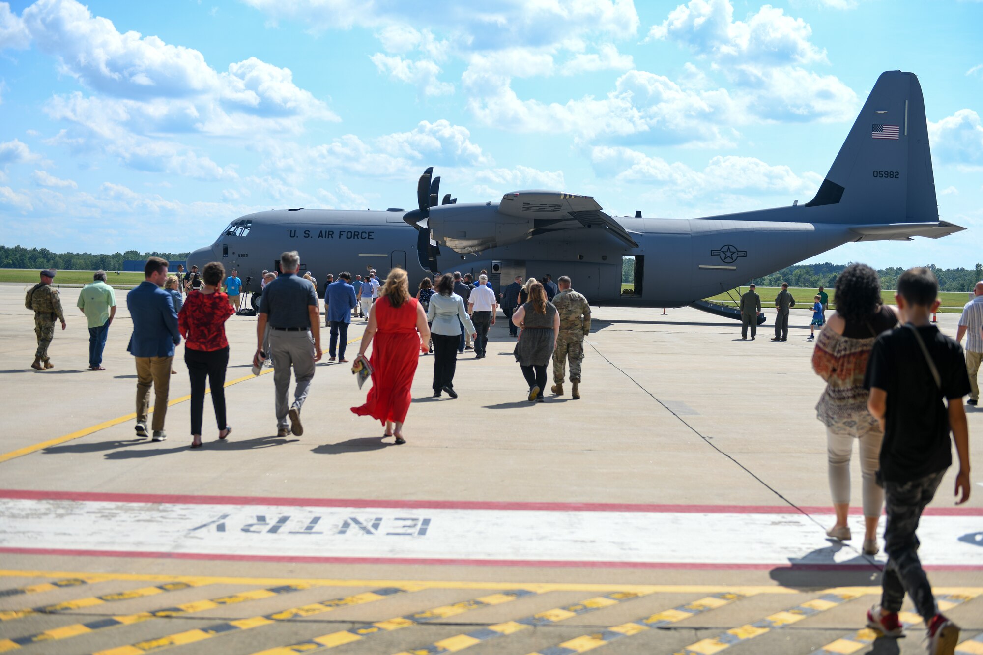 Citizen Airmen and invited guests attending the 910th Airlift Wing’s first C-130J-30 Super Hercules aircraft arrival ceremony on July 16, 2024, walk toward the new aircraft at Youngstown Air Reserve Station, Ohio.