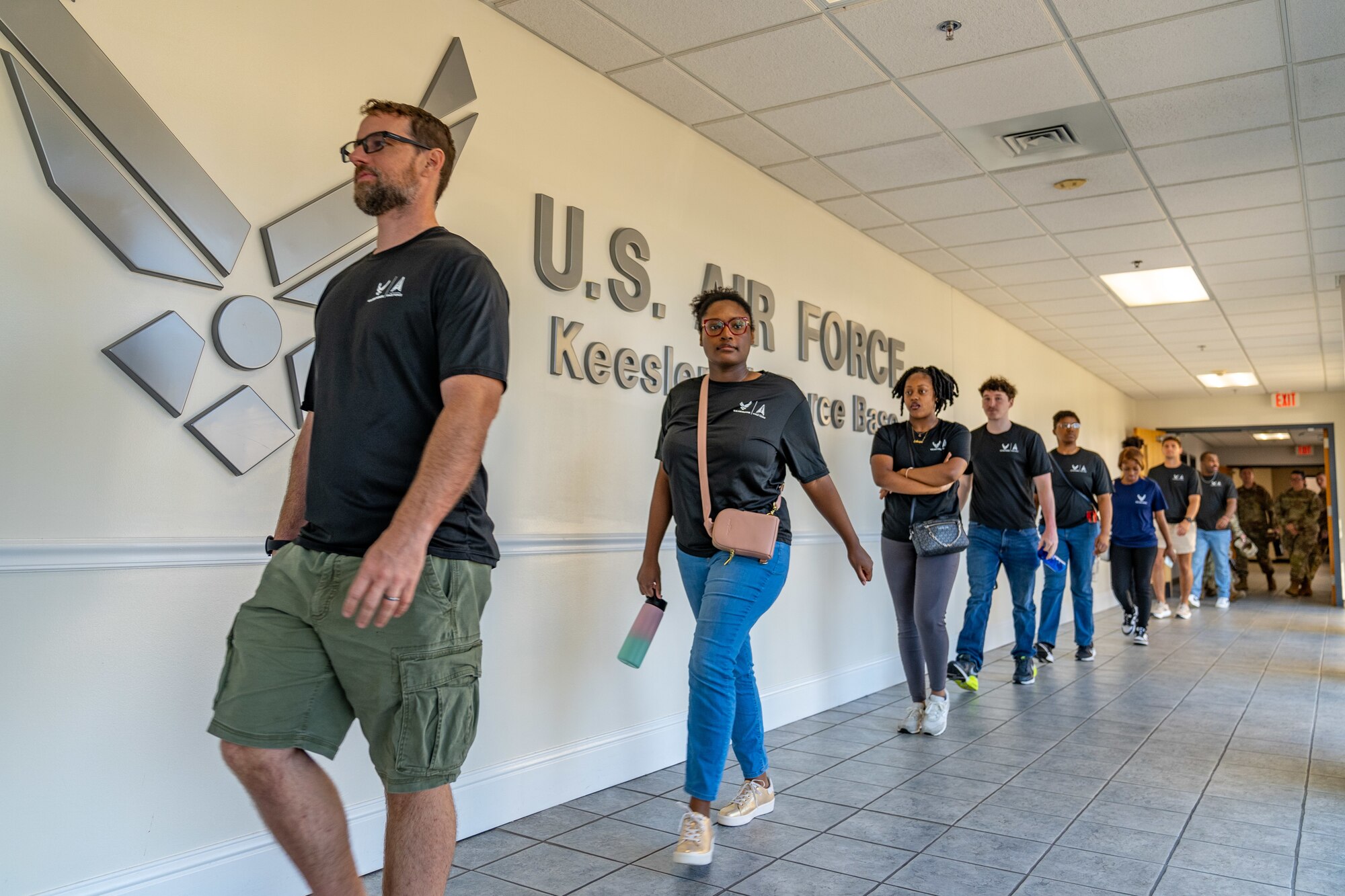 Enlistees assigned to the 331st Recruiting Squadron delayed entry program walk to the Fishbowl at the Levitow Training Support Facility during their tour of Keesler Air Force Base, Mississippi, July 11, 2024. These future Airmen and Guardians received the tour to better understand the various career fields within the Air Force and Space Force.  (U.S. Air Force photo by Andrew Young)