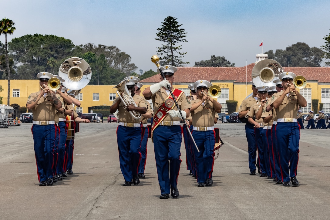 U.S. Marines with Marine Band San Diego march in formation during a graduation ceremony for India Company, 3rd Recruit Training Battalion, Marine Corps Recruit Depot San Diego, California, July 12, 2024. Graduation took place at the completion of the 13-week transformation, which included training for drill, marksmanship, basic combat skills, and Marine Corps customs and traditions. (U.S. Marine Corps photo by Cpl. Alexander O. Devereux)