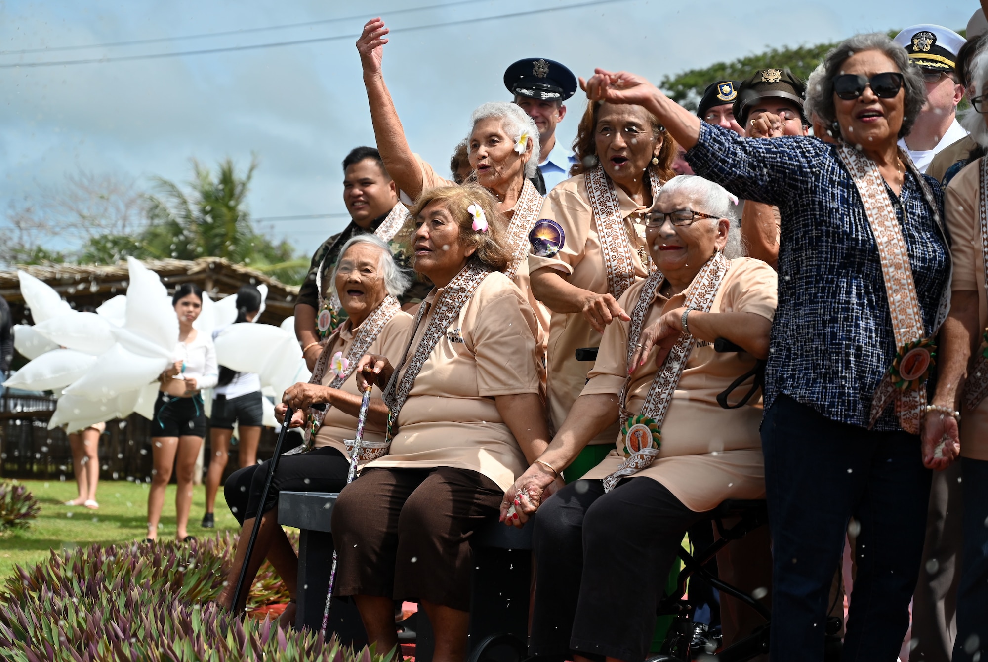 World War II survivors throw rice in commemoration of the 80th Hasso Inalåhan War Memorial at Agfayan Bay, Inalåhan, Guam on July 17, 2024. The rice was thrown in remembrance of the rice patty fields that many Chamorros once worked on during the war. (U.S. Air Force photo by Airman 1st Class Natasha Ninete)