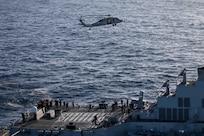 Santa Claus, flying in an MH-60S Sea Hawk, attached to the "Tridents" of Helicopter Sea Combat Squadron (HSC) 9, greets Sailors assigned to the Arleigh Burke guided-missile destroyer USS Bulkeley (DDG 84) in the Mediterranean Sea, Dec. 24, 2023. The Gerald R. Ford Carrier Strike Group is currently operating in the Mediterranean Sea. The U.S. maintains forward-deployed, ready, and postured forces to deter aggression and support security and stability around the world. (U.S. Navy photo by Mass Communication Specialist 2nd Class Jacob Mattingly)