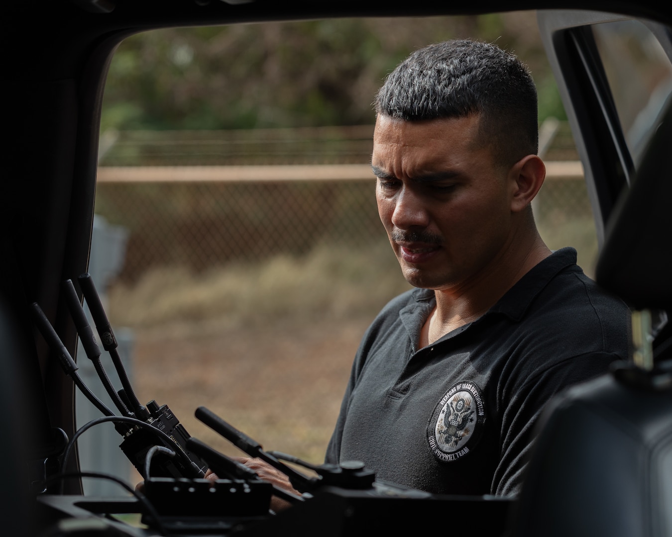 U.S. Army Sgt. 1st Class Daniel F. Billingsley, communications chief, 33rd Weapons of Mass Destruction-Civil Support Team, tests radio transmissions during a training exercise in Lihue, Hawaii, June 7, 2024. The exercise included military and civilian response partners to better integrate capabilities when disaster strikes.