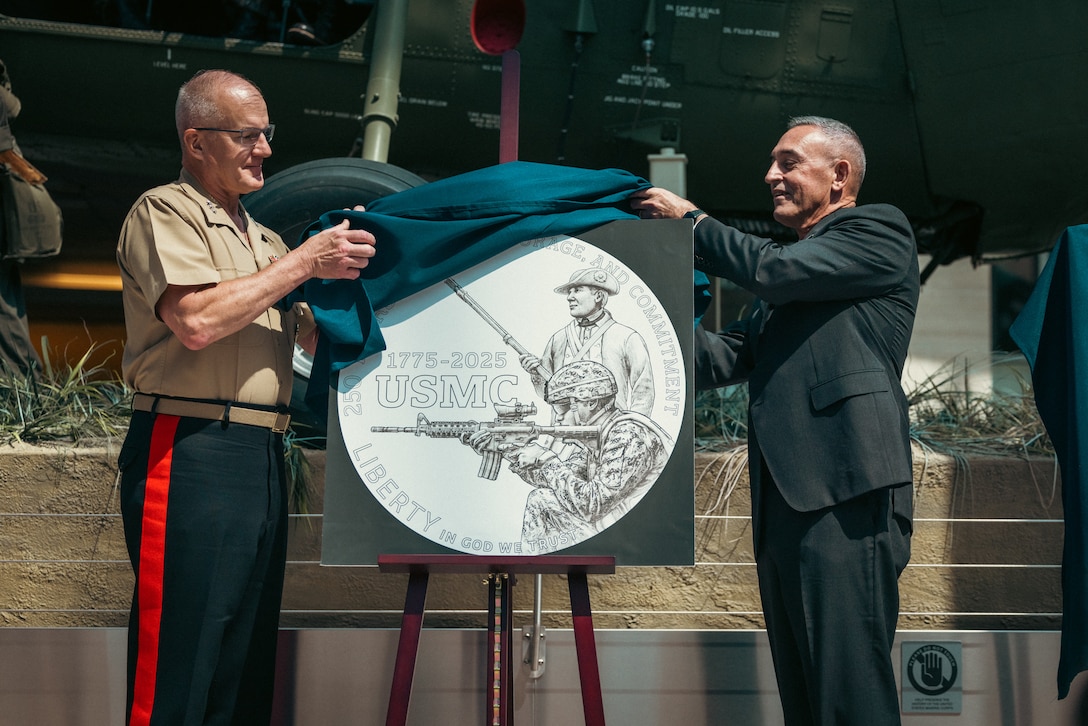 U.S. Marine Corps Lt. Gen. Gregg Olson, director of Marine Corps Staff, left, and retired U.S. Marine Corps Maj. Gen. James Lukeman, president and CEO of the Marine Corps Heritage Foundation, unveil the new trio of commemorative coins dedicated to the 250-year anniversary of the U.S. Marine Corps at the National Museum of the Marine Corps, Virginia, July 17, 2024. The coins are a testament to the courage, sacrifice and dedication of all Marines, ensuring that their stories will be remembered and celebrated. (U.S. Marine Corps photo by Lance Cpl. Joaquin Dela Torre)