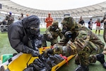 U.S. Army 2nd Lt. Jonathan Morrison, assigned to the 24th Civil Support Team, New York National Guard, puts a simulated casualty on a litter with Brazilian Army soldiers assigned to the 1st Battalion, Defense Quimica Biological Radiological Nuclear, during Operation Maracanã in Rio de Janeiro, July 12, 2024. Operation Maracana is a training exercise between the NYNG and Brazilian Armed Forces at the Maracanã stadium in preparation for the World Cup in 2026.