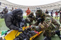 U.S. Army 2nd Lt. Jonathan Morrison, assigned to the 24th Civil Support Team, New York National Guard, puts a simulated casualty on a litter with Brazilian Army soldiers assigned to the 1st Battalion, Defense Quimica Biological Radiological Nuclear, during Operation Maracanã in Rio de Janeiro, July 12, 2024. Operation Maracana is a training exercise between the NYNG and Brazilian Armed Forces at the Maracanã stadium in preparation for the World Cup in 2026.