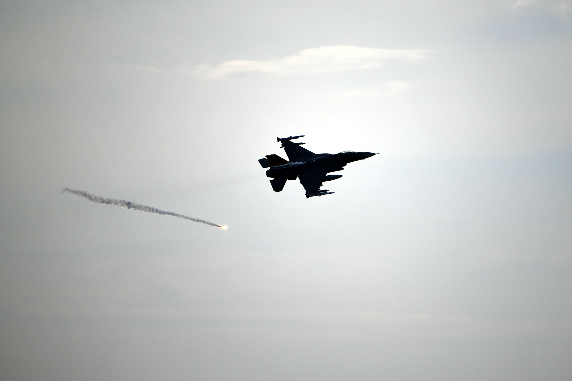 A U.S. Air Force F-16C Fighting Falcon assigned to the 79th Fighter Squadron deploys a flare during intercept training over South Carolina, June 27, 2024. The week-long training partnered pilots and aircraft from the 79th FS and Civil Air Patrol, aiming to teach and expand upon infrequently-used skills such as flying slower than the F-16’s normal tactical speeds and utilizing communications-out visual signals. (U.S. Air Force photo by Staff Sgt. Kelsey Owen)