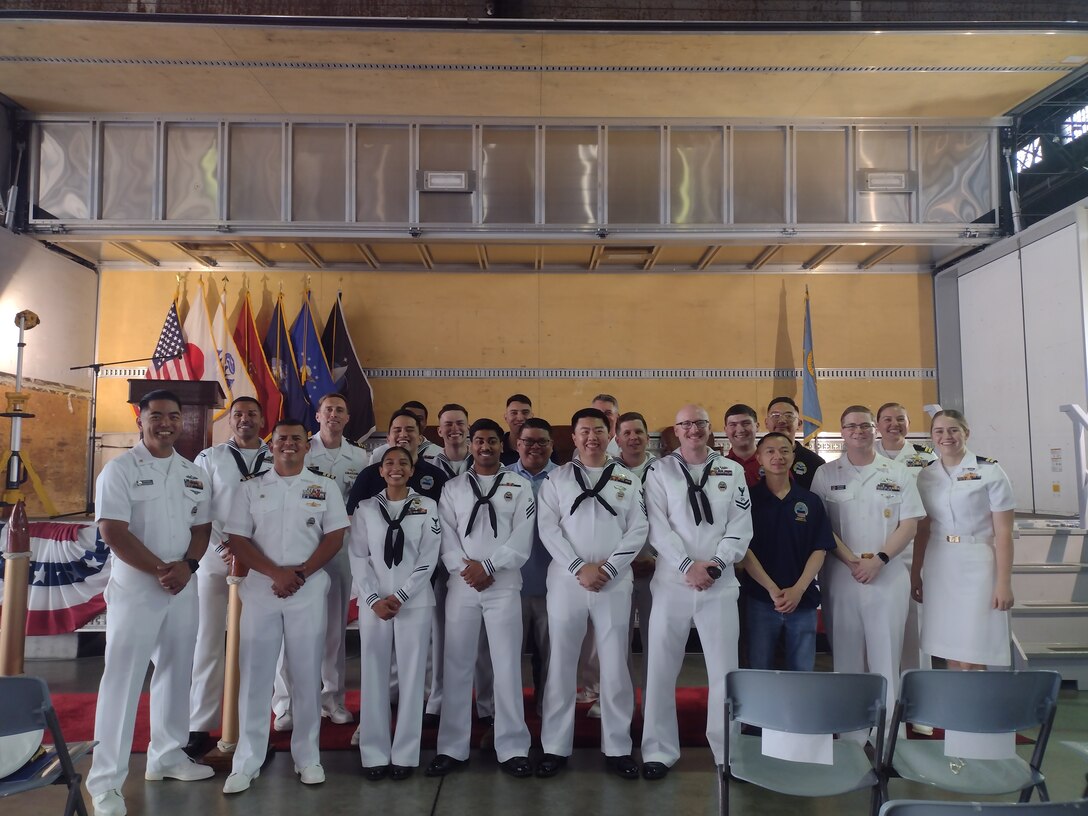 various civilian and military employees at a ceremony and reception.