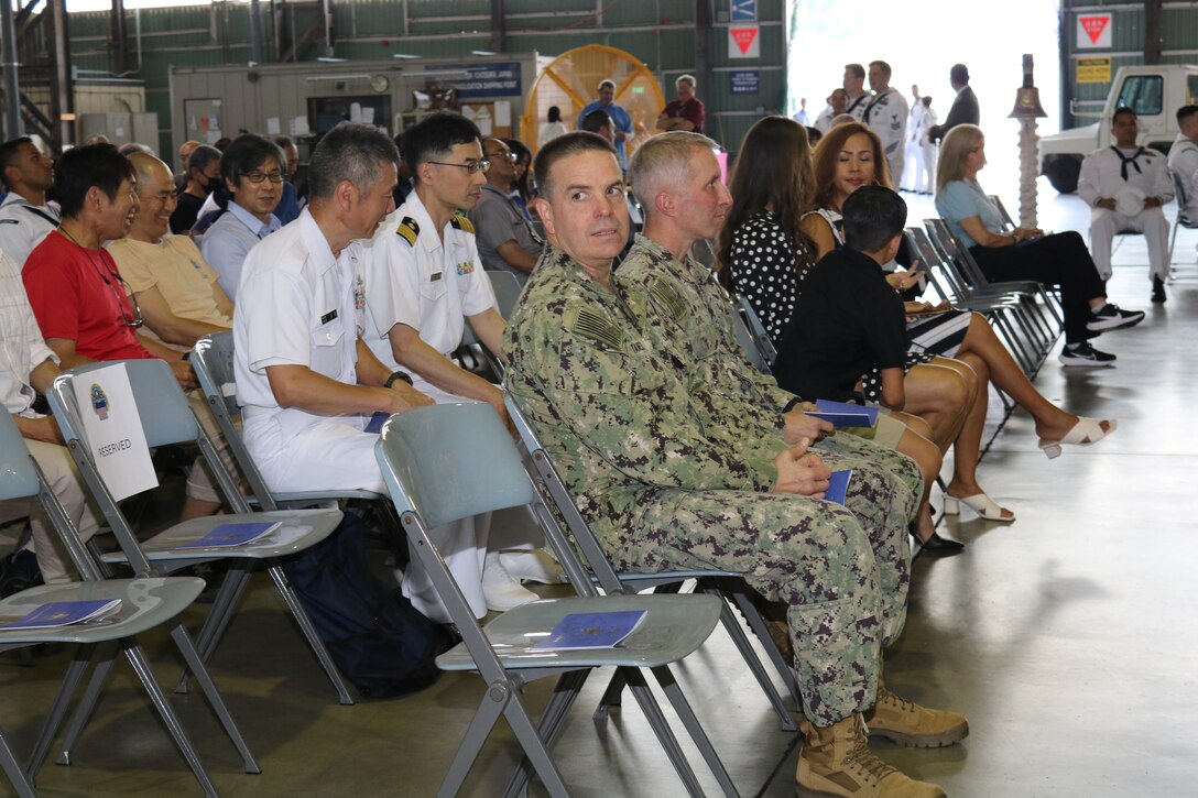 various civilian and military employees at a ceremony and reception.