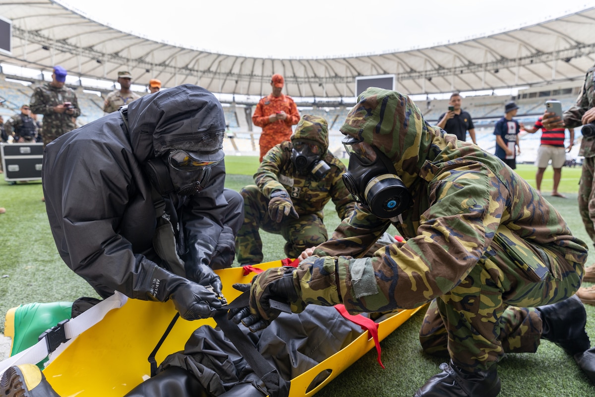 U.S. Army 2nd Lt. Jonathan Morrison, assigned to the 24th Civil Support Team, New York National Guard, puts a simulated casualty on a litter with Brazilian Army soldiers assigned to the 1st Battalion, Defense Quimica Biological Radiological Nuclear, during Operation Maracanã in Rio de Janeiro, July 12, 2024. Operation Maracana is a training exercise between the NYNG and Brazilian Armed Forces at the Maracanã stadium in preparation for the World Cup in 2026.