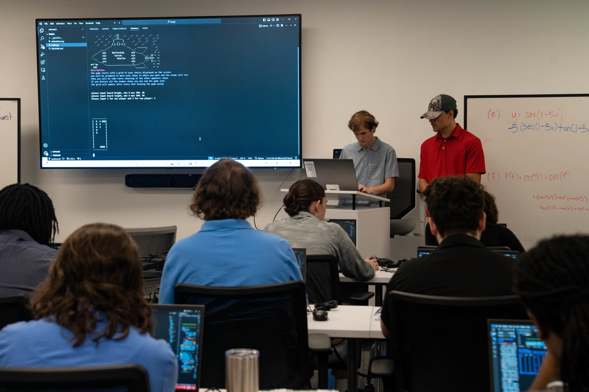 Classroom photo with people sitting and standing