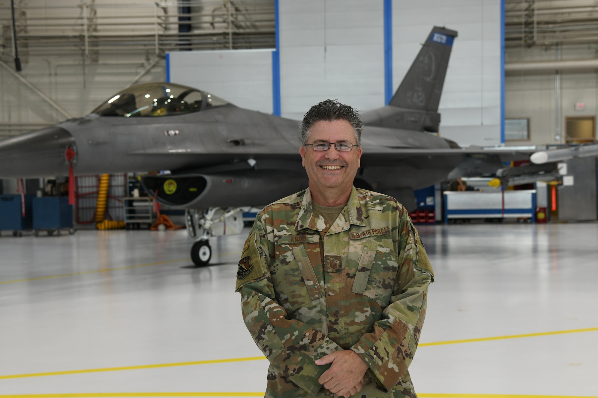 Master Sgt. Tom Krob, an aircraft hydraulic systems specialist, 148th Fighter Wing, Minnesota Air National Guard, stands in front of an F-16 Fighting Falcon at the Duluth Air National Guard Base. Krob is retiring in July 2024 with more than 42 years of service to his state and nation.