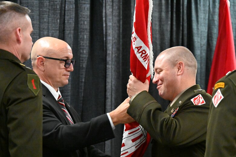 U.S. Army Lt. Col. Lyle Milliman receives a U.S. Army Corps of Engineers district flag from David Romano during a change of command ceremony