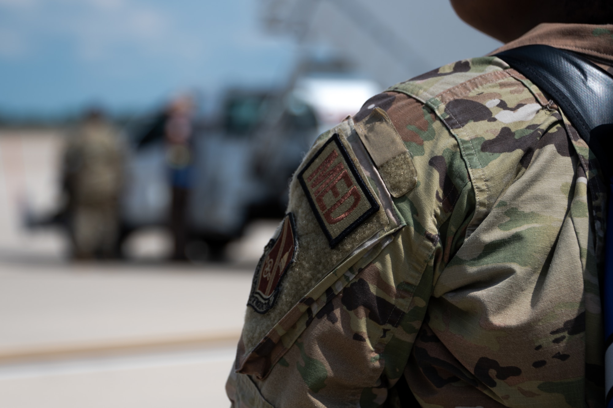 A patch that is velcroed on a U.S. Air Force service member's uniform spelled out in red lettering of M, E, and D.