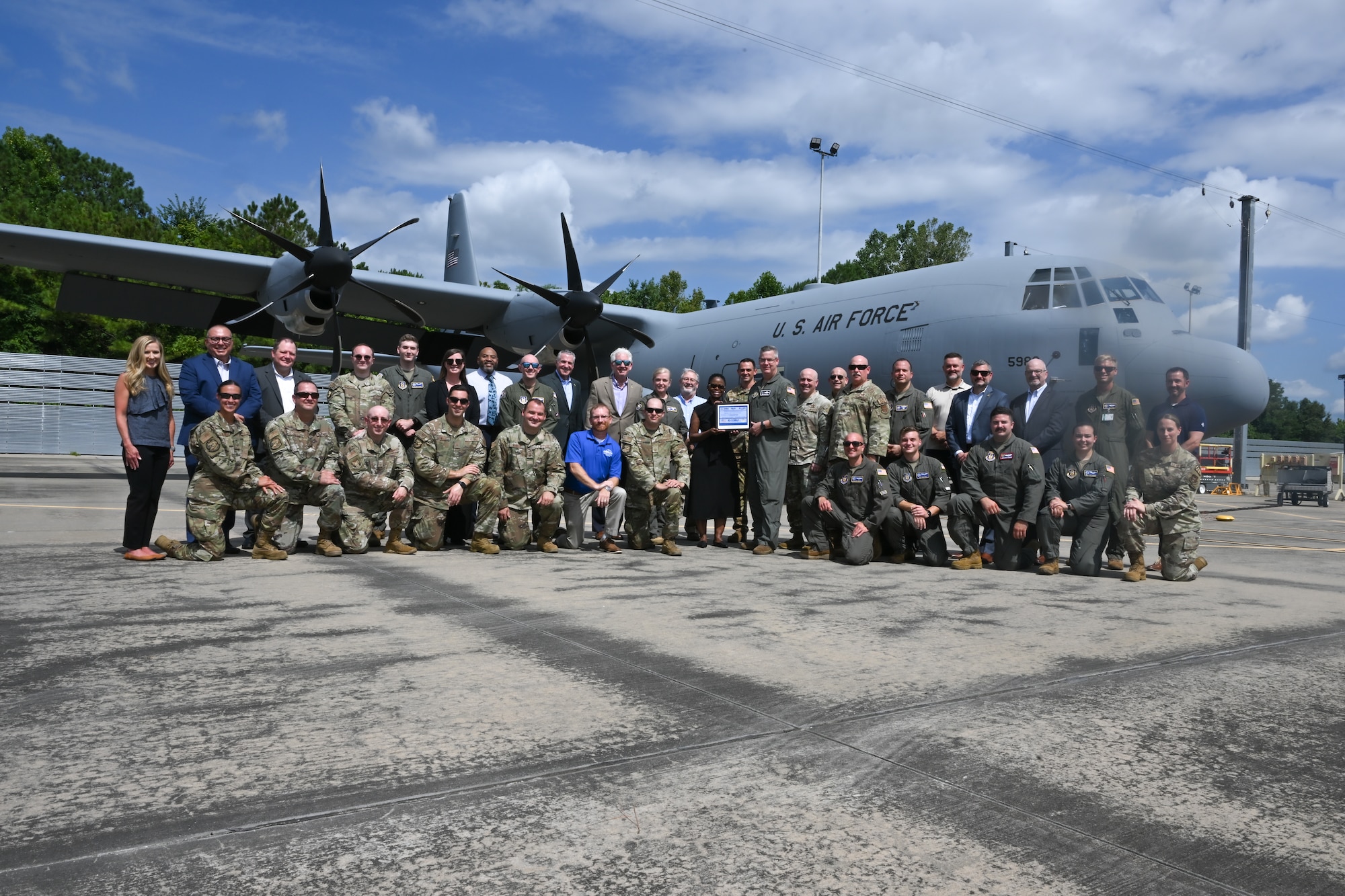 Members from 22nd Air Force, 910th Airlift Wing and Lockheed Martin pose for a photo during the key ceremony for the new C-130J-30 Super Hercules at the Lockheed Martin production facility, Marietta, Georgia, July 16, 2024.