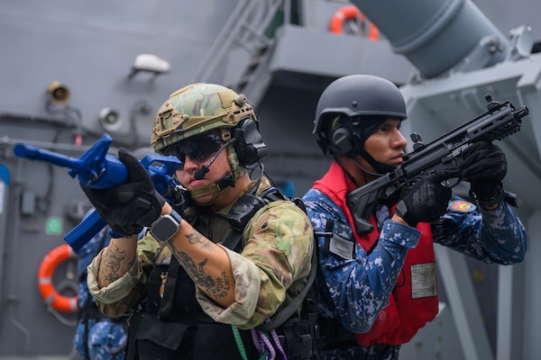 U.S Navy Quartermaster 1st Class Alexis Wighaman, assigned to the Arleigh Burke-class guided-missile destroyer USS Gridley (DDG 101), left, and Mexican navy Ensign Adrian Riveroll, assigned to the Mexican Reformador-class frigate ARM Belito Juárez (POLA-101), await further instructions during a visit, board, search and seizure (VBSS) drill aboard the Singaporean Formidable-class stealth frigate RSS Stalwart (72) as part of Exercise Rim of the Pacific (RIMPAC) 2024, July 15.