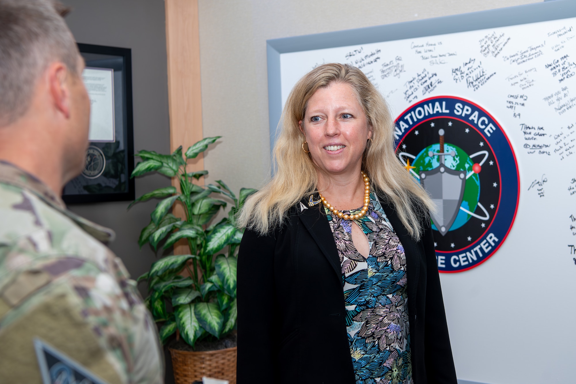 Woman smiling at military member in uniform