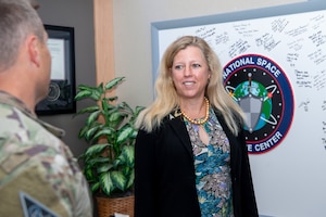 Woman smiling at military member in uniform