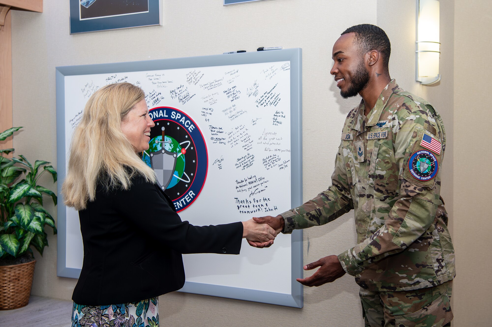 Woman shaking hands with uniformed military member