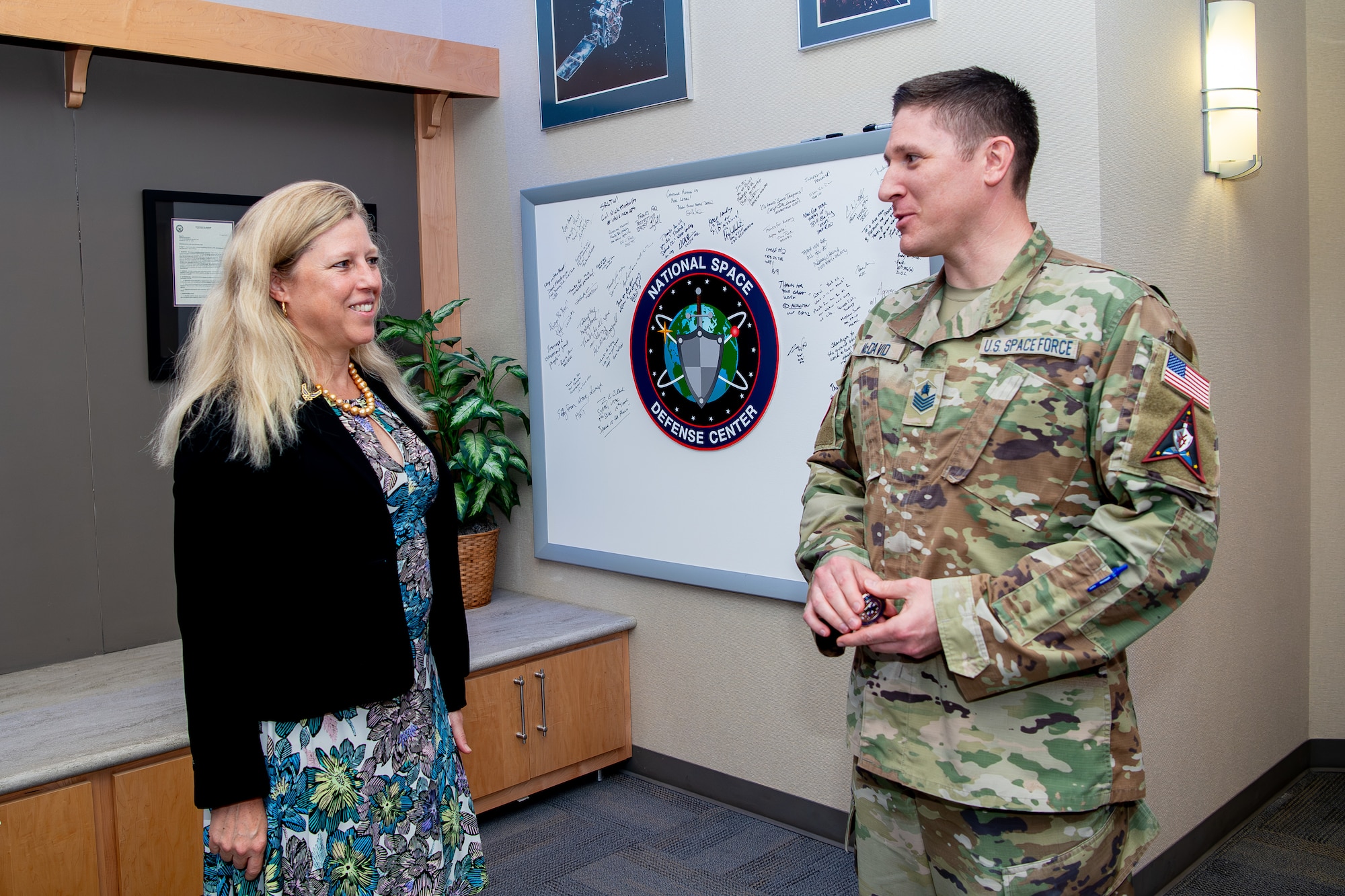 Woman speaking to military member in uniform
