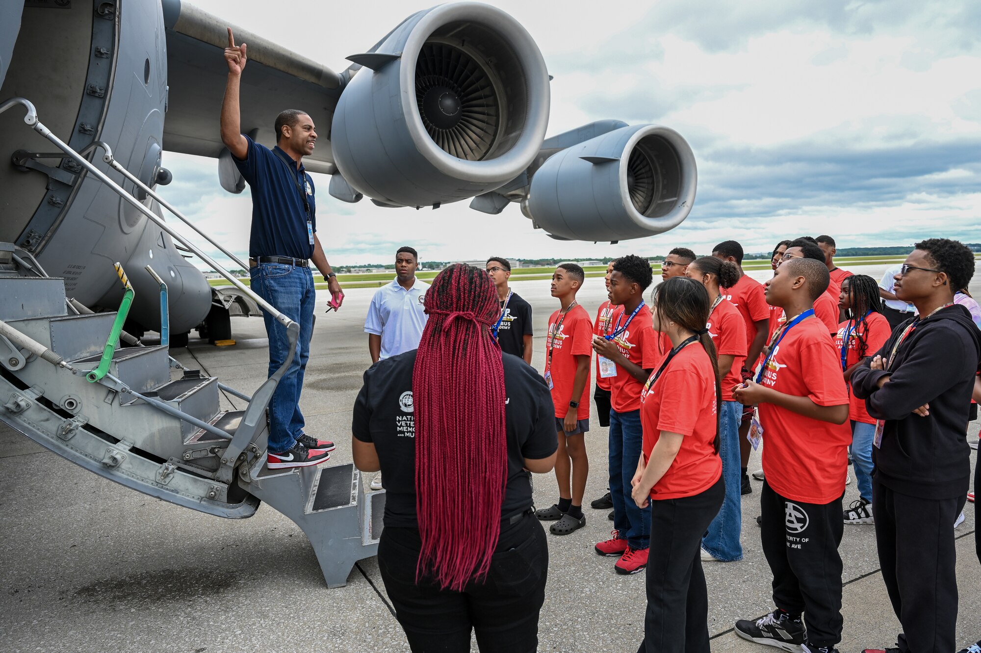 Lt. Col. Andrew Pierce, 89th Airlift Squadron flight commander/C-17 instructor pilot and Ohio Organization of Black Aerospace Professionals Ace Academy Buckeye Tigers Aviation Program director, prepares young members of Buckeye Tigers for boarding a C-17 Globemaster III during a tour of the 445th Airlift Wing at Wright-Patterson Air Force Base, Ohio, July 10, 2024. The Buckeye Tigers Aviation Program is an aviation organization focused on exposing young adults in middle and high school to various aviation careers in the Columbus and greater Central Ohio region.  (Aviation Career Education) Academy. (U.S. Air Force photo by Mr. Patrick OReilly)