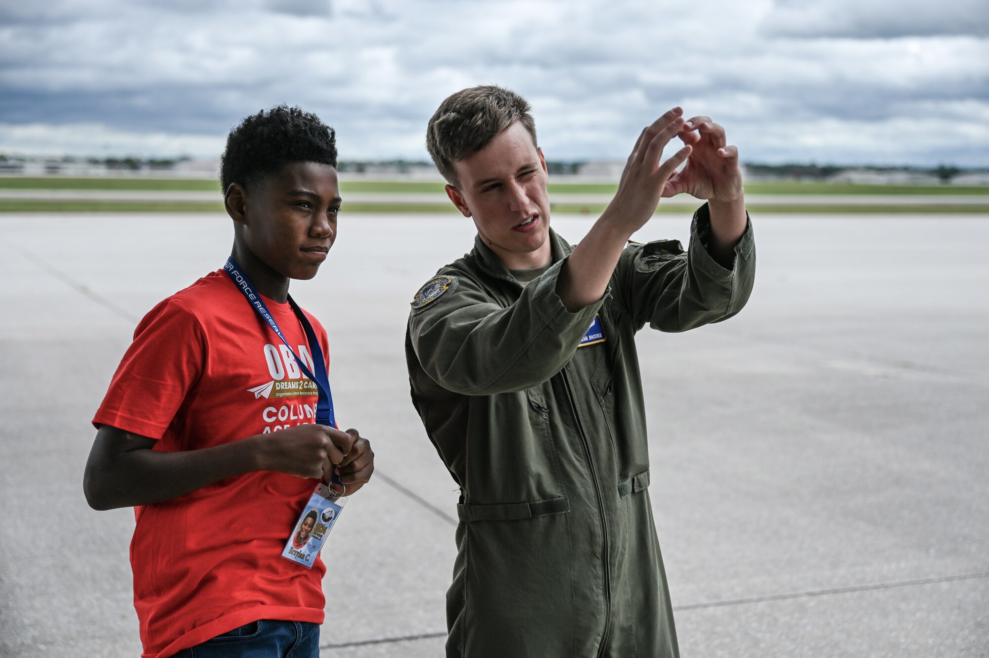 Senior Airman Diegan Rhodes, 89th Airlift Squadron loadmaster, talks to a young member of Buckeye Tigers during a tour of the 445th Airlift Wing at Wright-Patterson Air Force Base, Ohio, July 10, 2024. The Buckeye Tigers Aviation Program is an aviation organization focused on exposing young adults in middle and high school to various aviation careers in the Columbus and greater Central Ohio region.  Members get to experience actual flight in a real single engine airplane as the culminating event of OBAP’s (Organization of Black Aerospace Professionals) sponsored A.C.E. (Aviation Career Education) Academy. (U.S. Air Force photo by Mr. Patrick OReilly)
