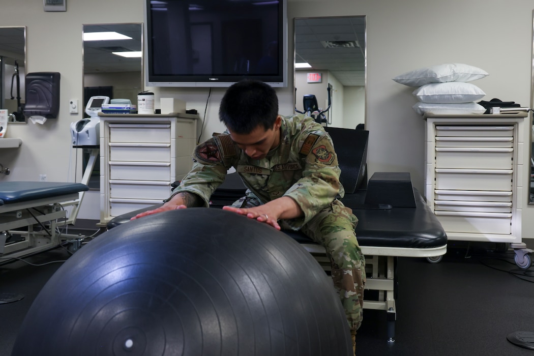 U.S. Air Force Airman 1st Class Nicholas Santos, 375th Medical Group physical therapy technician, Keesler Air Force Base, Mississippi, demonstrates an exercise to a patient at the 9th Medical Group physical therapy clinic at Beale Air Force Base, California, July 12, 2024.