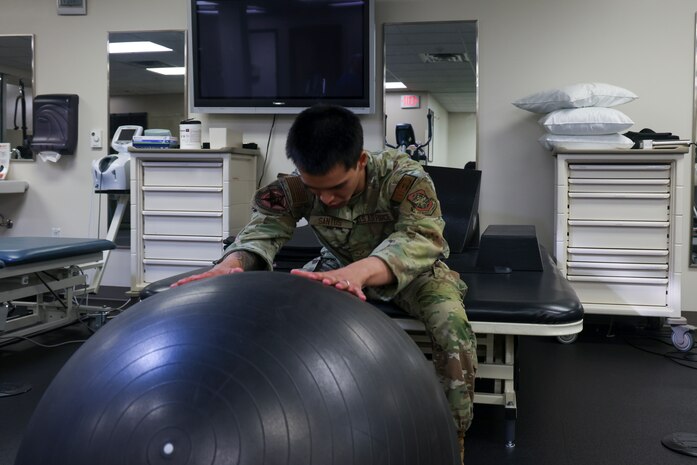 U.S. Air Force Airman 1st Class Nicholas Santos, 375th Medical Group physical therapy technician, Keesler Air Force Base, Mississippi, demonstrates an exercise to a patient at the 9th Medical Group physical therapy clinic at Beale Air Force Base, California, July 12, 2024.