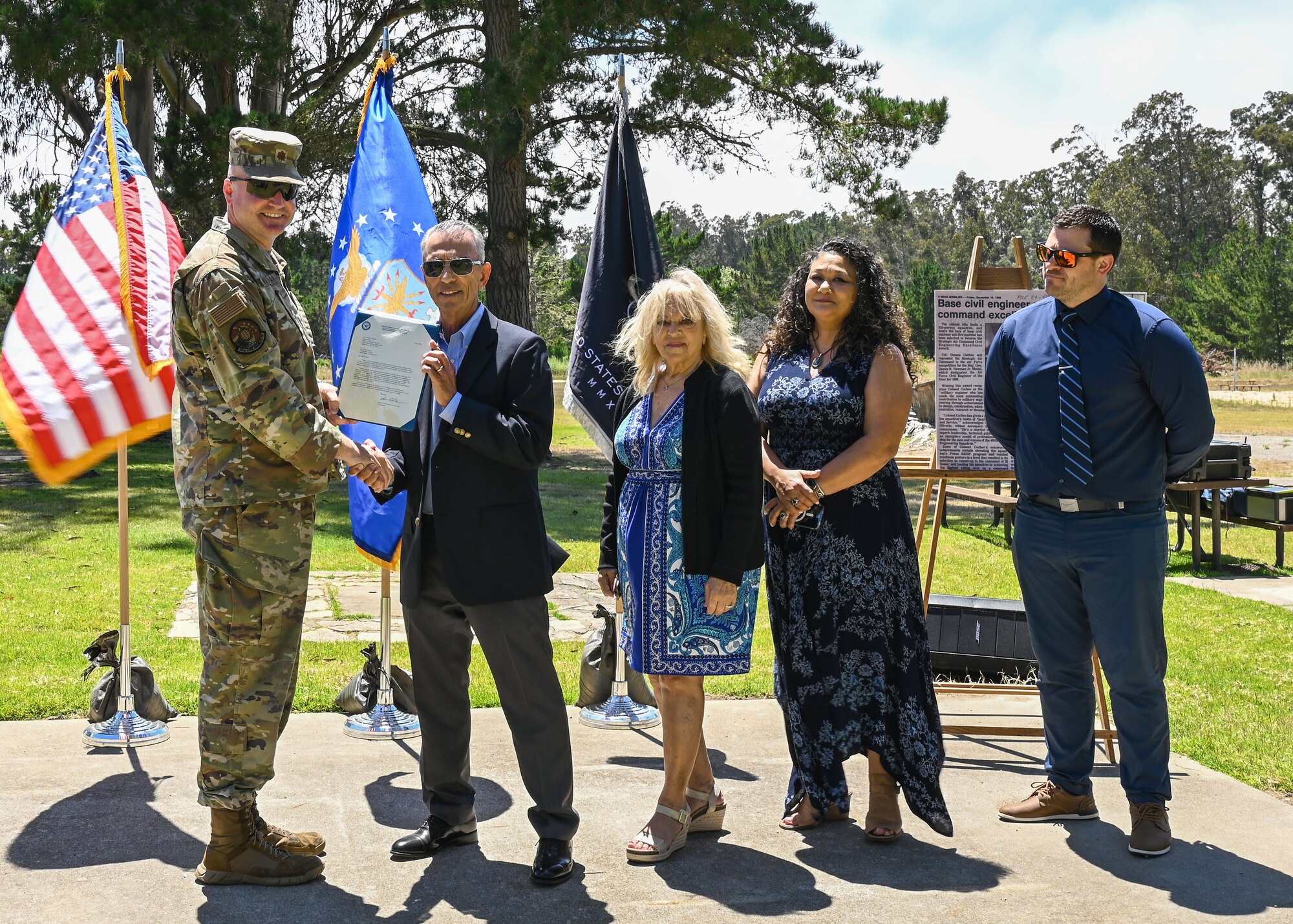 A 30th Civil Engineer Squadron commander, presents Victor Cocheo, brother of late U.S. Air Force 4392d Civil Engineer Squadron former commander, with a certificate during the Cocheo Park Commemoration Ceremony at Vandenberg Space Force Base.