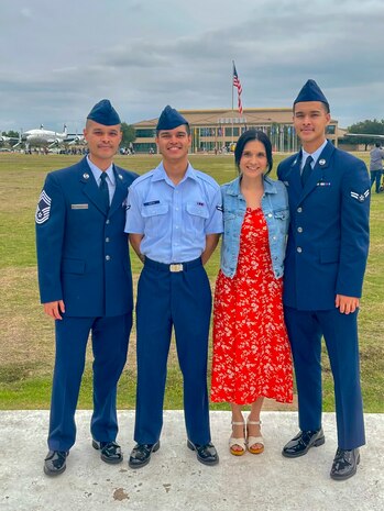 U.S. Air Force Chief Master Sgt. Charles Santos, 9th Medical Group senior enlisted leader (left), A1C Anthony Santos, 81st Medical Group physical therapy technician (center), Adelaida Santos, 9th Communications Squadron commanders administrative assistant, and 1st Class Nicholas Santos, 375th Medical Group physical therapy technician, pose together at A1C Anthony Santos's Basic Military Training graduation at Lackland Air Force Base, Texas, November 9, 2023.