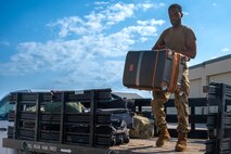 A 5th Logistic Readiness Squadron air transportation specialist removes luggage from a truck while preparing passengers to depart in support of exercise AGILE WARBIRD at Minot Air Force Base, North Dakota, July 13, 2024. AGILE WARBIRD is an Agile Combat Employment exercise designed to validate a wing’s ability to deploy, employ and sustain forces, and execute priority mission essential tasks in a degraded and operationally limited environment. (U.S. Air Force photo by Senior Airman Alexander Nottingham)