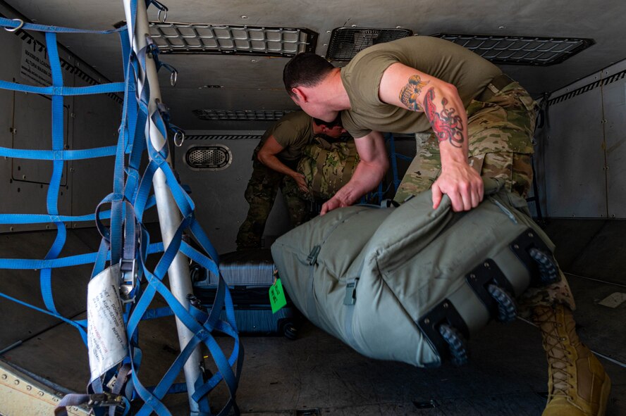 Team Minot Airmen pack luggage onto a passenger jet in preparation for exercise AGILE WARBIRD at Minot Air Force Base, North Dakota, July 13, 2024. AGILE WARBIRD demonstrates Minot's ability to shift operations from centralized physical infrastructures to a network of smaller, dispersed locations that can complicate adversary planning and provide more options for joint force commanders. (U.S. Air Force photo by Senior Airman Alexander Nottingham)