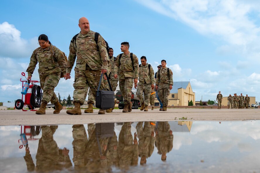 Team Minot Airmen walk towards a passenger jet in preparation for exercise AGILE WARBIRD at Minot Air Force Base, North Dakota, July 13, 2024. Airmen participating in AGILE WARBIRD were distributed to different bases across the U.S. to practice Agile Combat Employment and demonstrate that the Warbird mission can be accomplished anywhere. (U.S. Air Force photo by Senior Airman Alexander Nottingham)