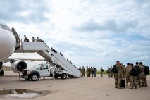Team Minot Airmen board a passenger jet in preparation for exercise AGILE WARBIRD at Minot Air Force Base, North Dakota, July 13, 2024. AGILE WARBIRD Airmen were distributed to different bases across the U.S. to practice Agile Combat Employment. (U.S. Air Force photo by Senior Airman Alexander Nottingham)