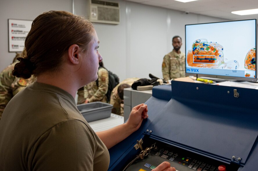 A 5th Logistics Readiness Squadron air transportation specialist observes an X-ray security scanner monitor at the Minot Air Force Base (AFB) passenger terminal in preparation for exercise AGILE WARBIRD at Minot AFB North Dakota, June 13, 2024. Air transportation specialists are responsible for securely managing cargo and passengers, and ensuring everything and everyone on a military aircraft is transported safely and quickly. (U.S. Air Force photo by Senior Airman Alexander Nottingham)