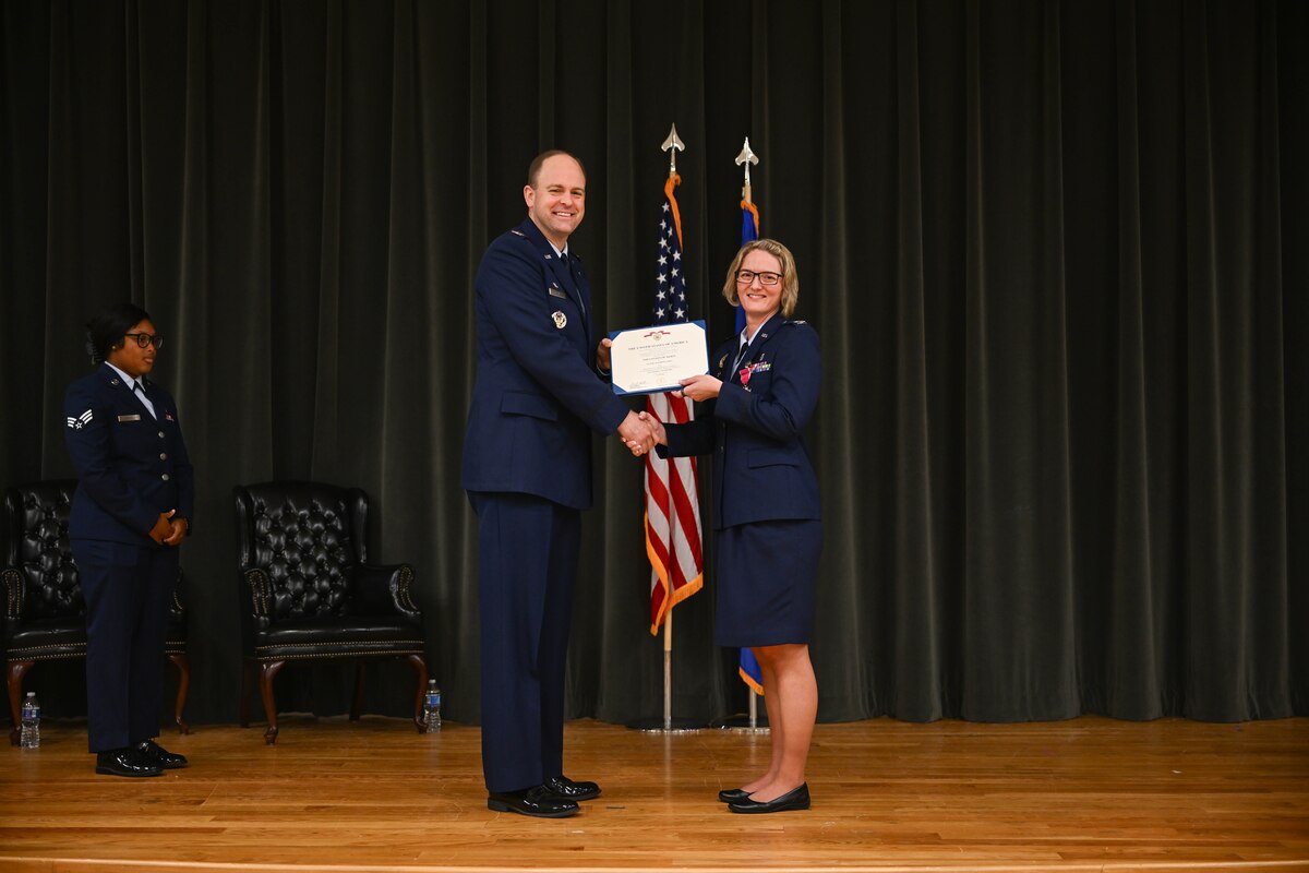Two military members pose for a photo.
