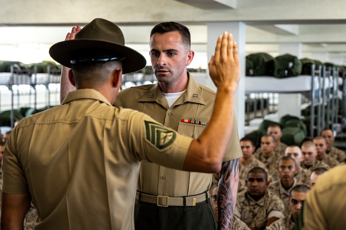 U.S. Marine Corps Capt. Matthew Spencer, a series commander for Lima Company, 3rd Recruit Training Battalion, swears in drill instructors during a pick-up event at Marine Corps Recruit Depot San Diego, California, July 12, 2024. During pick-up recruits meet their drill instructors and are briefed on the rules and expectations of their training. (U.S. Marine Corps photo by Lance Cpl. Eric Valerio)