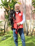 Emma, a 14-year-old black Shih Tzu, has been a volunteer therapy dog with the American Red Cross Animal Visitation Program since 2012. Emma and handler Richard Smith volunteer at Tripler Army Medical Center.