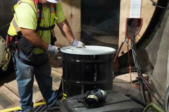 HALAWA, Hawaii (June 28, 2024) A Navy Closure Task Force-Red Hill (NCTF-RH) contractor seals a 55-gallon drum containing sludge removed from fuel tank 8 at the Red Hill Bulk Fuel Storage Facility (RHBFSF) in Halawa, Hawaii, June 28, 2024. About 25 gallons were removed from the tank, which was recently ventilated. Charged with the safe decommissioning of the RHBFSF, NCTF-RH was established by the Department of the Navy as a commitment to the community and the environment. (U.S. Navy photo by Mass Communication Specialist 1st Class Glenn Slaughter)