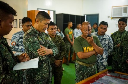 Philippine Marines, Navy, sailors and Coast Guard service members assigned to Joint Task Force Tawi-Tawi, Western Mindanao Command radio their response during ato a Joint Maritime Security Training Exercise training scenario in Tawi-Tawi, Philippines, April 18, 2024.