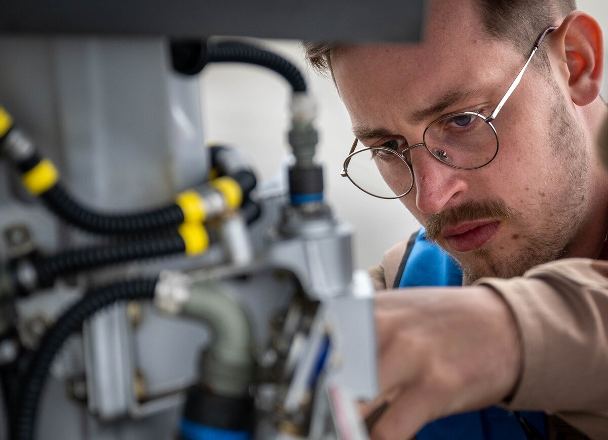 A French Air and Space Force avionic technician performs routine maintenance on a Rafale fighter jet during Arctic Defender 24 at Eielson Air Force Base, Alaska, July 9, 2024. AD24 is a component of Pacific Skies 24, a months-long deployment hosted by the German Air Force. Germany, France and Spain are partners in the trinational Future Combat Air System, and as the first stop in their deployment, AD24 is used to conduct realistic, total force combat training to maintain a free and open Indo-Pacific region through mission readiness and deterrence. (U.S. Air Force photo by Staff Sgt. Kelsea Caballero)