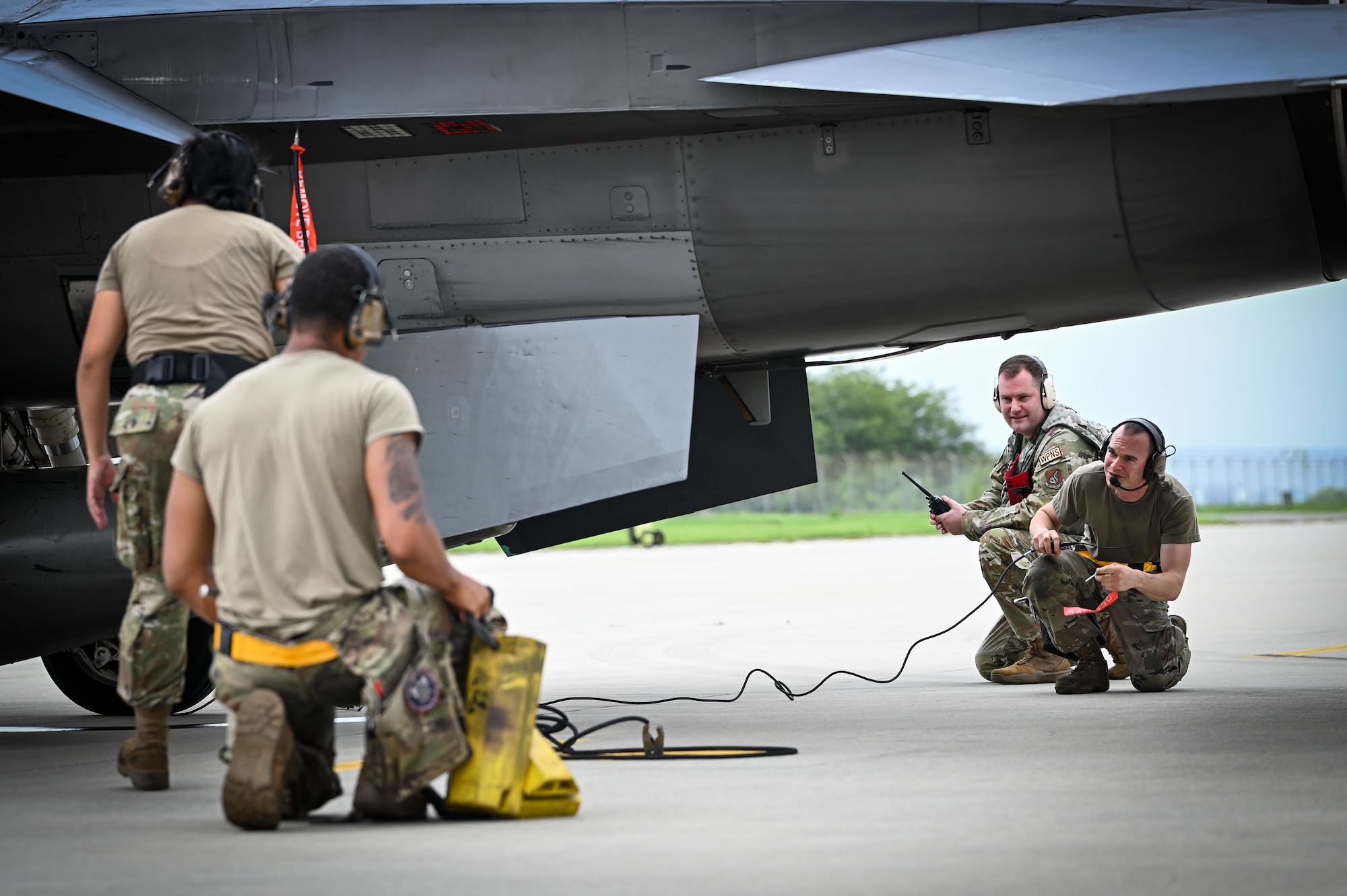 From the left, Airman Joselyne Jacobo, 80th Fighter Generation Squadron weapons load crew member, Airman Joseph De Anda, 80th FGS weapons load crew member, and Staff Sgt. Anthony Godlewski, far right, 80th FGS weapons load crew chief, conduct a hung ordnance and gun procedure while being evaluated by Master Sgt. Anthony Bagent, back, 8th Maintenance Group weapons standardization superintendent, during exercise Beverly Sentinel 24-2.